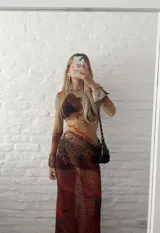 Vestido midi de microtul elastizado con estampado abstracto en tonos marrones y beige. Diseño ajustado al cuerpo, de manga larga y cuello redondo. Transparenta.