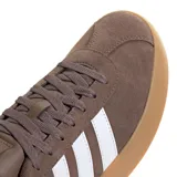 Championes urbanos Adidas modelo Court VL 3.0, color marrón con las icónicas tres tiras en blanco. Presentan una capellada de gamuza, cordones al tono y una suela de goma vulcanizada en color caramelo.