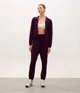 Campera deportiva de modal negro con capucha, cierre frontal por cremallera, cordones ajustables, bolsillos y mangas largas con puños elásticos.
