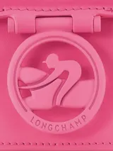 Bandolera Longchamp modelo Box-Trot XS, color morado, con correa fina al hombro y logo circular en el frente.