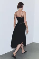 Vestido midi de tirantes finos con escote recto y detalle de encaje a tono en el escote y la cintura. Presenta un diseño con bajo asimétrico y falda con caída fluida.