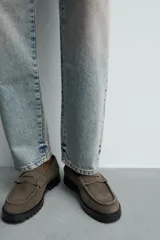 Mocasín de vestir en piel con acabado serraje color verde militar, con detalle de antifaz en el empeine y suela track dentada.