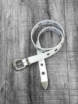 Cinto blanco de cuero sintético con hebilla metálica plateada y ojales metálicos.