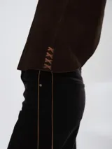 Chaleco de cuero azul marino con corte oversize, diseño sin mangas y laterales ajustables mediante cordones de cuero en tono natural.