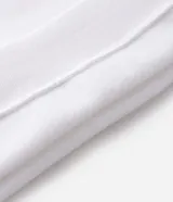Buzo deportivo de felpa en color blanco con detalles en negro. Presenta cuello tipo polo, mangas largas con puños acanalados y diseño con recortes laterales. Incluye estampados gráficos en el frente con tipografía cursiva y emblema circular.