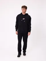 Babucha gris de algodón y poliéster, con cintura elástica, cordón ajustable y bolsillos laterales. Presenta el logo de Rusty bordado en el muslo izquierdo.