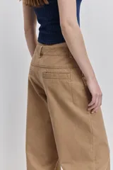 Pantalón verde militar de tiro medio y calce wide leg, con bolsillos laterales y cierre frontal con botón.