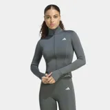 Campera deportiva entallada Adidas Optime Essentials color gris, con cuello alto, cierre frontal completo, mangas largas con aberturas para los pulgares y logo de la marca en blanco.