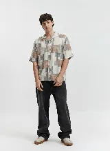 Camisa de manga corta con cuello tipo pijama y estampado con bloques geométricos en tonos beige, marrón y gris. Confeccionada en viscosa.