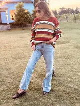 Sweater de lana con rayas horizontales en tonos rojo, ocre, marrón y blanco.