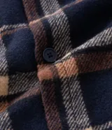 Campera tipo trucker de franela con estampado de cuadros, cuello inglés, cierre frontal con botones, bolsillos con solapa en el pecho y bolsillos laterales. Cuenta con forro interno de sherpa para mayor calidez.