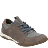 Sneaker Hush Puppies modelo Space, con diseño de paneles en cuero y tejido mesh. Presenta cordones azules, cuello de lycra para mayor ajuste y suela de goma con entresuela de EVA para amortiguación.
