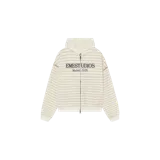 Campera con capucha y cierre frontal completo Eme Studios modelo Capri Off Sand, con diseño a rayas horizontales en tonos beige y blanco, bolsillos tipo canguro y estampado gráfico en el frente con el texto 'EMESTUDIOS Madrid, 5135'.