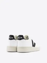 Zapatillas Veja V-10 de cuero blanco con logo lateral en forma de V color negro y refuerzo trasero negro.