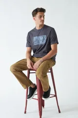 Remera de hombre color gris oscuro, manga corta y escote redondo, con un estampado rectangular frontal de motivos vegetales en tonos azules.