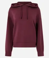 Buzo oversized de corte holgado, color beige, con capucha ajustable mediante cordones, mangas largas con puños elásticos y ruedo recto. Confeccionado en tejido de modal con acabado suave.