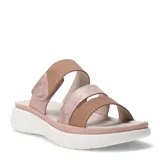 Sandalias de plataforma con diseño de tiras cruzadas en tonos beige y rosado metalizado. Presentan una tira superior con cierre de velcro ajustable y suela de goma blanca con relieve.
