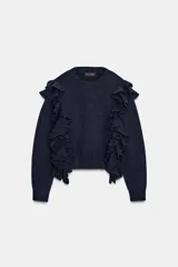 Jersey de punto color azul marino, con cuello redondo, manga larga y volantes decorativos en el frente y los hombros.