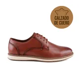 Zapato de vestir acordonado color marrón de cuero con suela blanca.