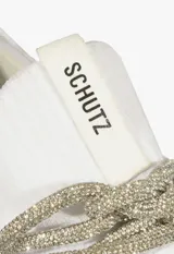 Championes deportivos Schutz de color blanco, confeccionados en tejido de punto con suela de goma a tono. Presentan un diseño moderno con cordones decorativos de lurex brillante y detalle de marca en la lengüeta.
