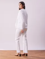 Chaqueta color crema de algodón con bolsillos simulados y terminación desflecada.