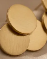 Caravanas de acero con baño de oro, compuestas por tres discos circulares superpuestos de diferentes tamaños.
