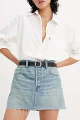 Minifalda de jean celeste con lavado claro, tiro alto, cinco bolsillos, cierre frontal con botón metálico y ruedo desflecado.