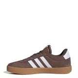 Championes urbanos Adidas modelo Court VL 3.0, confeccionados en gamuza color marrón con las icónicas tres tiras laterales en blanco. Presentan suela de goma color tostado y logo de la marca en la lengüeta.