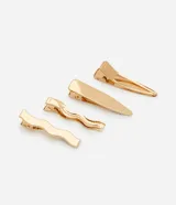 Set de cuatro pinzas para el pelo doradas, con diferentes diseños: dos onduladas y dos lisas.