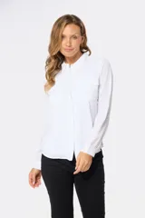 Blusa tipo camisa blanca de manga larga con botones nacarados ocultos con cartera. Tela suave y sedosa con doble capa en el frente para evitar transparencias.