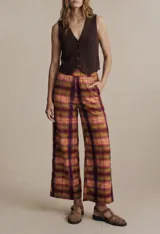 Chaleco de punto color beige con cuello en V y cierre frontal con botones.