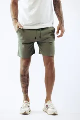 Shorts de algodón color rosa viejo, estilo jogging, con cordón ajustable en la cintura y corte por encima de la rodilla.