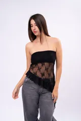 Top strapless de encaje negro con diseño asimétrico y detalle de volado en el ruedo. La prenda combina una parte superior lisa con una sección inferior de encaje transparente con motivos florales.