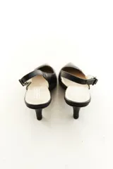 Zapatos slingback de cuero color beige con punta fina, taco medio y tira ajustable en el talón.
