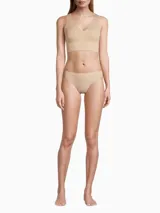 Colaless color beige de microfibra suave con bordes cortados a láser y cintura de tiro medio con logo de Calvin Klein estampado.