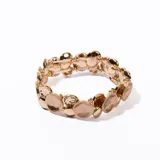 Pulsera elástica dorada con apliques circulares texturizados.