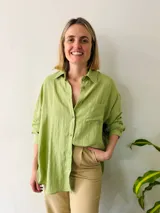 Camisa verde de lino, corte amplio y largo, con cuello clásico y mangas largas.