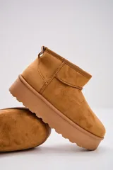 Bota corta tipo ugg de gamuza color camel, con plataforma plana y suela dentada.