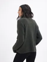 Buzo de tejido acanalado color beige, con cuello alto y cierre frontal parcial. Presenta mangas largas y un diseño de calce regular.