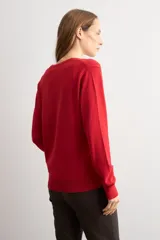 Sweater de punto color rojo, con escote en V y mangas largas, de calce clásico.