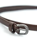 Cinturon fino de cuero sintetico color marron, con hebilla metalica plateada con detalles grabados de estilo western.