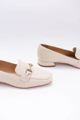 Mocasines de cuero color verde oliva, con detalle de herraje metálico dorado en el empeine y taco bajo cuadrado.