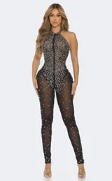 Body entero de corte ajustado confeccionado en tela transparente con aplicaciones de cristales distribuidos por toda la prenda. Presenta cuello halter y cierre frontal completo.