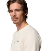 Remera estilo Henley de manga corta color blanco marfil, con cuello redondo acanalado, cierre frontal parcial con tres botones y parche con el logo de la marca Columbia en el pecho.
