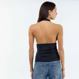 Top negro con cuello halter y escote en V pronunciado, de diseño ajustado con frunces laterales en el cuerpo.