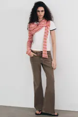 Jeans de tiro bajo con diseño bootcut y acabado flare en el bajo. Cuenta con cinco bolsillos, trabillas para cinturón y cierre frontal con cremallera y botón metálico.