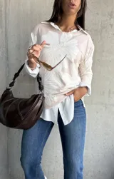 Sweater de punto con diseño floral en tonos crema y natural, de cuello redondo y manga larga.