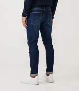 Pantalón de jean skinny azul oscuro con roturas en las rodillas y ruedo doblado.