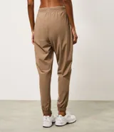 Pantalón jogger deportivo de microfibra, color tostado, con cintura elástica ajustable y puños elásticos en los tobillos. Diseño funcional y liviano, ideal para actividades físicas.