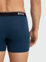 Pack de tres bóxers ajustados de algodón, color negro, con cintura elástica en contraste color azul petróleo y logo de la marca estampado en blanco.